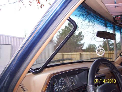 1990 Ford Bronco - Interior view of a 1990 Ford Bronco, highlighting the grab handle and dashboard.