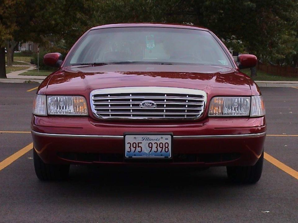 Front view of a dark red Ford Crown Victoria sedan with Illinois plate 395 9398 in a parking lot