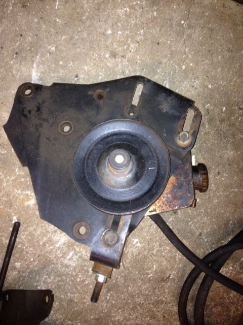 1994 Ford Bronco - Close-up of a vehicle's power steering pump bracket and pulley assembly.