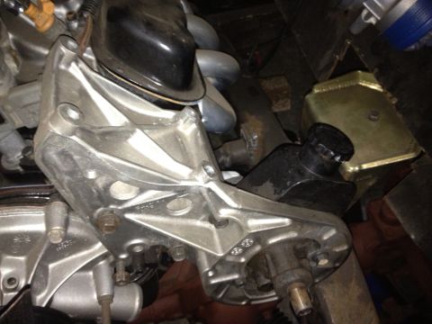 1994 Ford Bronco - A detailed view of an engine bracket, highlighting its metallic construction and mounting points.