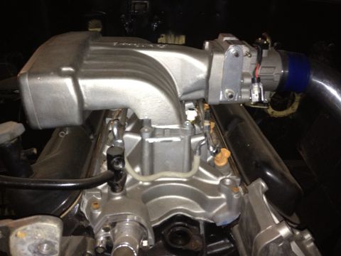 1994 Ford Bronco - This is a close-up view of an engine's intake manifold and associated components.