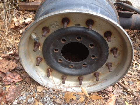 1994 Ford Bronco - This is a close-up view of a heavy-duty truck wheel rim, showing its lug nut pattern and valve stem.