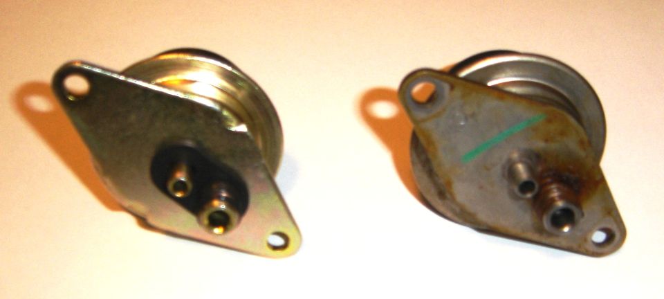 Two vacuum actuators, one clean, one rusted, with green mark on one