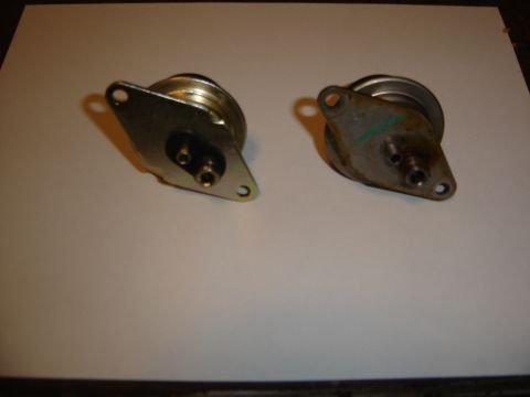 1996 Ford Bronco - Two vacuum actuators shown on a flat surface.