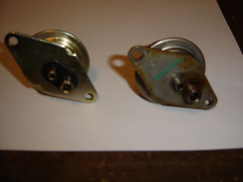 1996 Ford Bronco - Two automotive vacuum actuators are shown side-by-side on a white surface.
