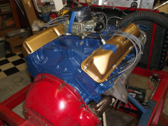 Gold valve covers on a blue V8 engine with a red transmission bell housing, 1969 Ford Torino
