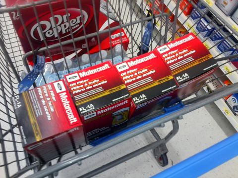 1984 Ford Bronco - Four Motorcraft FL-1A oil filters are visible in a shopping cart, alongside Dr. Pepper and bottled water.