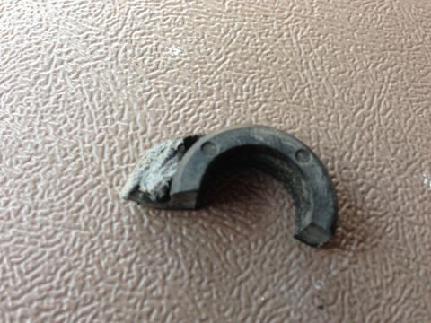 1996 Ford Bronco - A close-up of a damaged rubber seal, showing wear and tear on its surface.