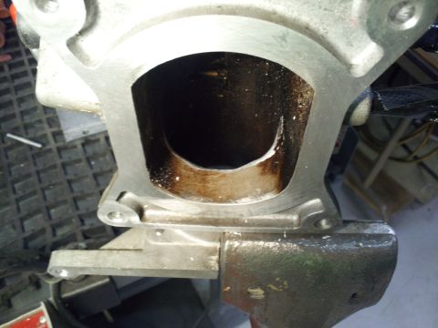 2000 Mercury Grand Marquis - Close-up view of an engine cylinder held in a vise, revealing significant carbon deposits and wear.