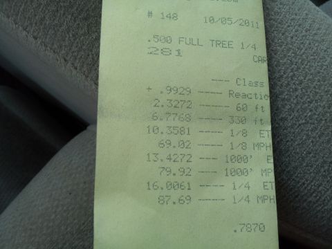 2000 Mercury Grand Marquis - A time slip document from a drag race shows various performance metrics and a website logo.