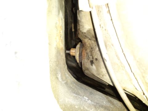2000 Mercury Grand Marquis - A close-up view of a bolt and washer assembly on the underside of a vehicle, showing mechanical components.
