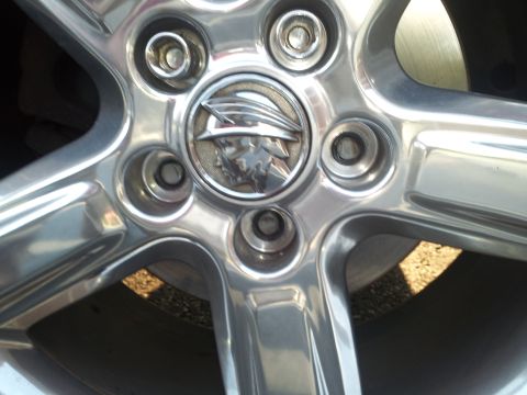 2000 Mercury Grand Marquis - Close-up of a chrome wheel the iconic Mercury emblem, likely from a 2000 Mercury Grand Marquis.