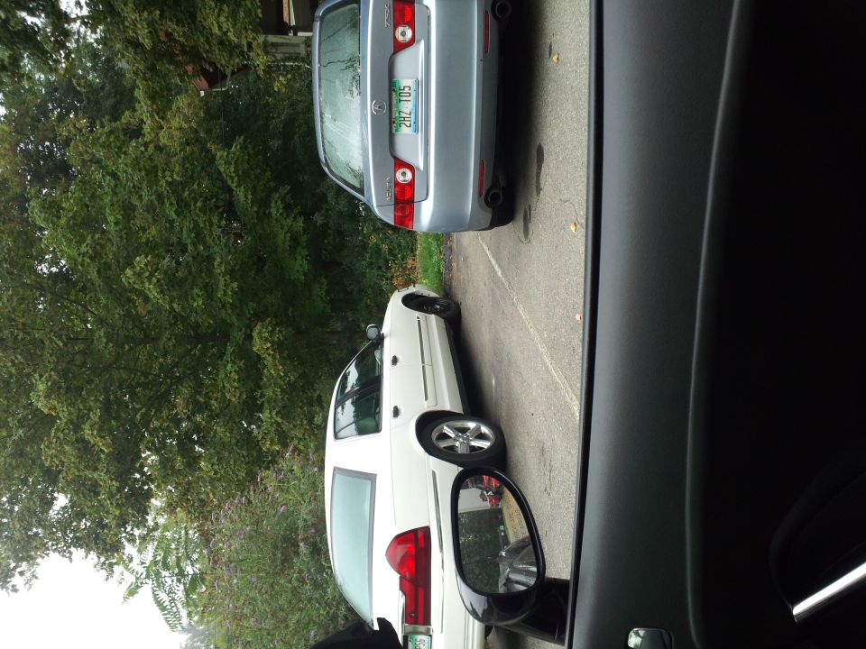 2000 Mercury Grand Marquis parked next to a silver sedan
