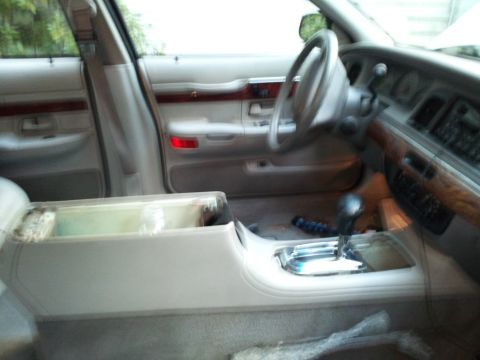 2000 Mercury Grand Marquis - The interior of a 2000 Mercury Grand Marquis, the dashboard, steering wheel, and center console area.