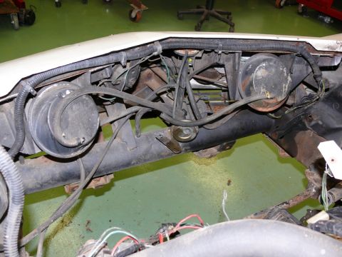 1976 Chevrolet Corvette - This image shows the front suspension and brake system of a vehicle, with various hoses and wires visible.