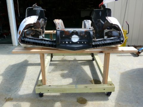 1976 Chevrolet Corvette - The front clip of a 1976 Chevrolet Corvette is disassembled and displayed on a wooden stand.