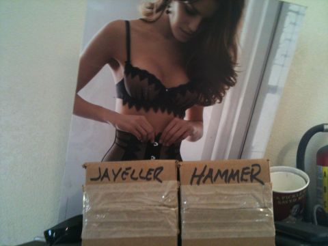 1966 Ford Bronco - A poster of a woman in lingerie is displayed above two cardboard boxes, one labeled JAYELLER and the other HAMMER.