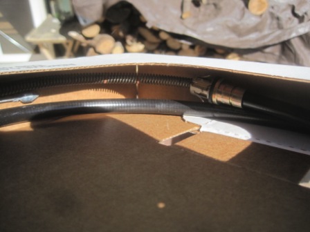 1993 Ford Bronco - A part, possibly a cable with a coiled spring, is shown inside a cardboard box. The registry label indicates it is for a 1993 Ford Bronco,…