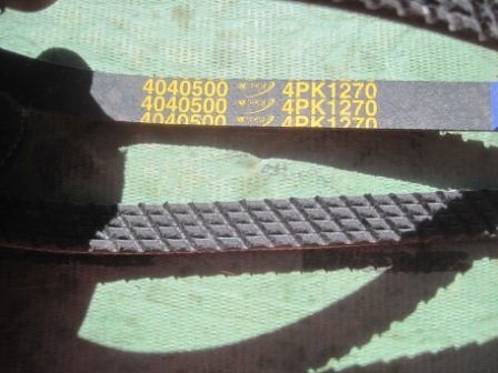 1993 Ford Bronco - Close-up of two automotive drive belts, one labeled 4040500 4PK1270.