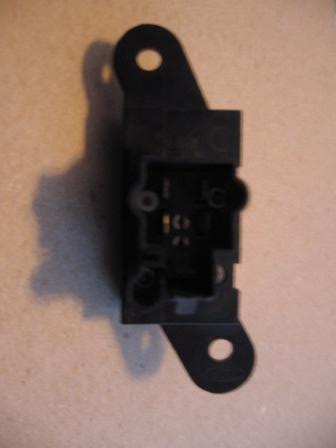1993 Ford Bronco - This is a close-up of a black plastic electrical component with visible internal contacts and mounting points.