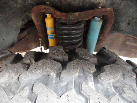 1995 Ford Bronco - Vehicle suspension components including shocks and coil spring are visible.