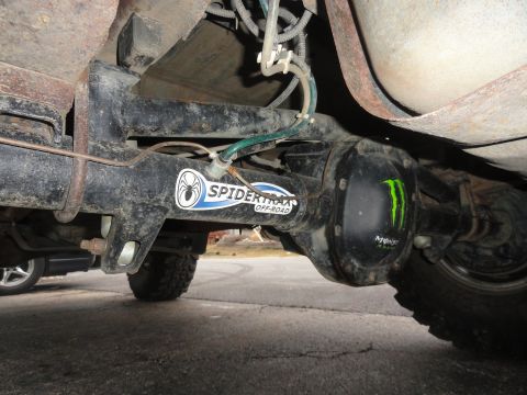 1995 Ford Bronco - Close-up of a modified rear axle Spidertrax Off-Road and Monster Energy branding.