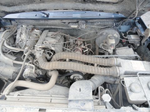 1995 Ford Bronco - Engine bay of a 1995 Ford Bronco showing the V8 engine and associated components.