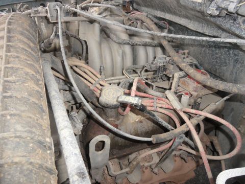 1995 Ford Bronco - Close-up view of a vehicle's engine compartment, showing various components and wiring.