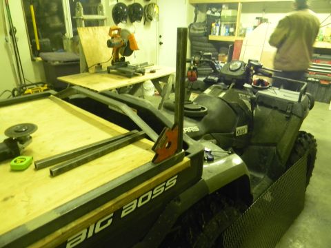 1990 Chevrolet Suburban - An all-terrain vehicle is parked in a garage with construction materials.
