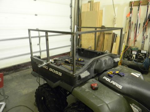 1990 Chevrolet Suburban - A Polaris ATV is shown from the rear with a newly fabricated metal frame installed on its cargo bed.
