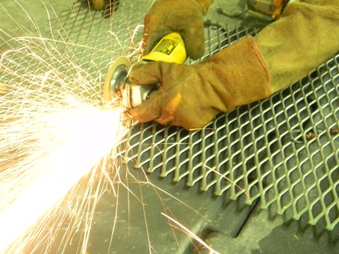 1990 Chevrolet Suburban - Grinding metal with an angle grinder produces many sparks.