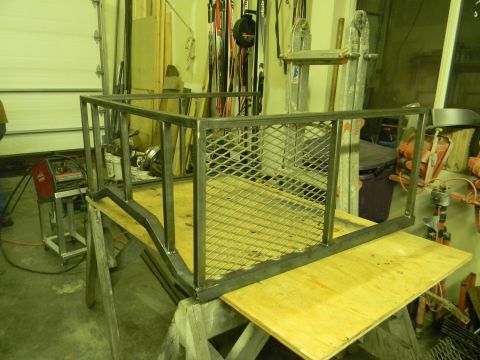 1990 Chevrolet Suburban - Metal rack construction in progress with welding equipment visible in the background.
