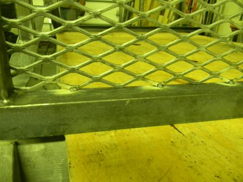 1990 Chevrolet Suburban - The photo shows a section of metal grating with a wooden surface underneath.