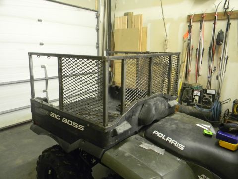 1990 Chevrolet Suburban - This Polaris ATV features a custom-built metal cargo bed, perfect for hauling.