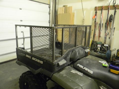 1990 Chevrolet Suburban - An ATV is equipped with a custom metal cargo rack, and the "BIG BOSS" and "POLARIS" brands are visible.