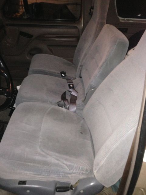 1996 Ford Bronco - The interior of a vehicle shows the front seats and part of the steering wheel.