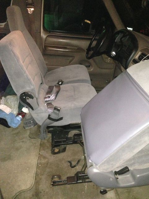 1996 Ford Bronco - Interior view of a truck's cabin, showing gray bucket seats and the steering wheel.