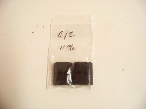 1995 Mercury Grand Marquis - Two small black rubber components are sealed in a plastic bag with handwritten labels.