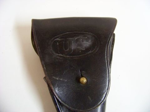 1995 Mercury Grand Marquis - This is a close-up view of a vintage leather holster with a "US" marking on its flap.