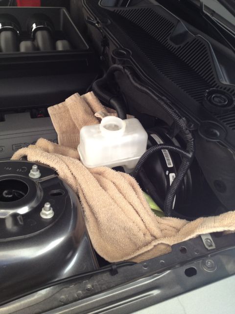 2013 Ford Mustang - A towel is placed over the brake fluid reservoir in the engine bay of a 2013 Ford Mustang.