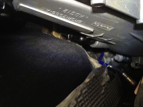 2013 Ford Mustang - A close-up view of a vehicle's engine component with Ford branding and part numbers visible.