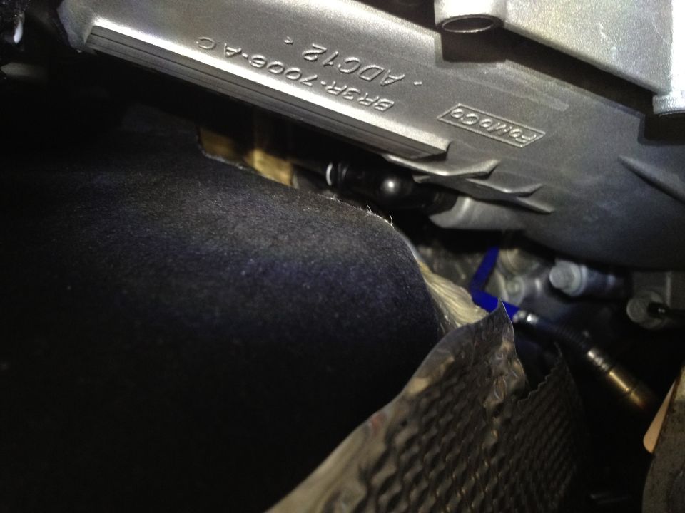 Close-up of a Ford part with text BR3R-7006-AC and ADC12