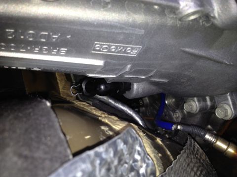 2013 Ford Mustang - Close-up view of a Ford engine component, showing part numbers and a blue hose connection.