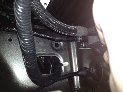 2013 Ford Mustang - Close-up view of the wiring harness in the engine bay of a 2013 Ford Mustang.