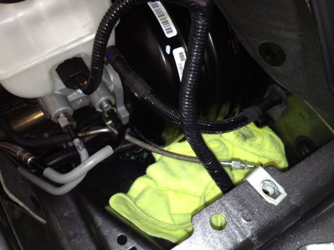 2013 Ford Mustang - Close-up view of the brake master cylinder and booster assembly.