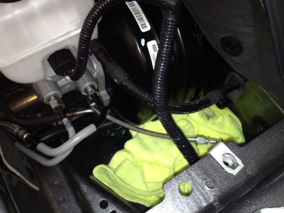 Brake master cylinder and booster assembly with yellow rag underneath