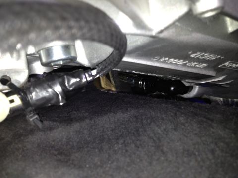 2013 Ford Mustang - A close-up view of a vehicle's wiring harness, partially covered by black electrical tape.