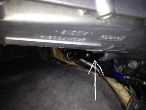 2013 Ford Mustang - Close-up view of a vehicle's undercarriage, showing mechanical components and wiring.