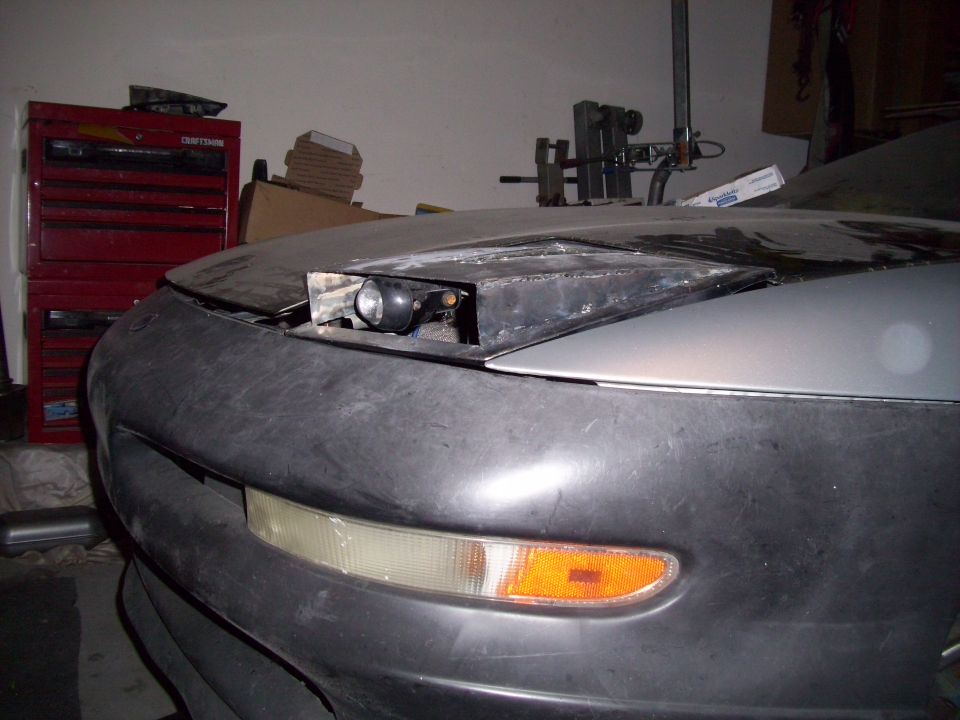 1995 Ford Probe front end showing pop-up headlight assembly removed