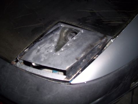 1995 Ford Probe - The headlight assembly on this vehicle shows signs of modification or damage, with exposed components.